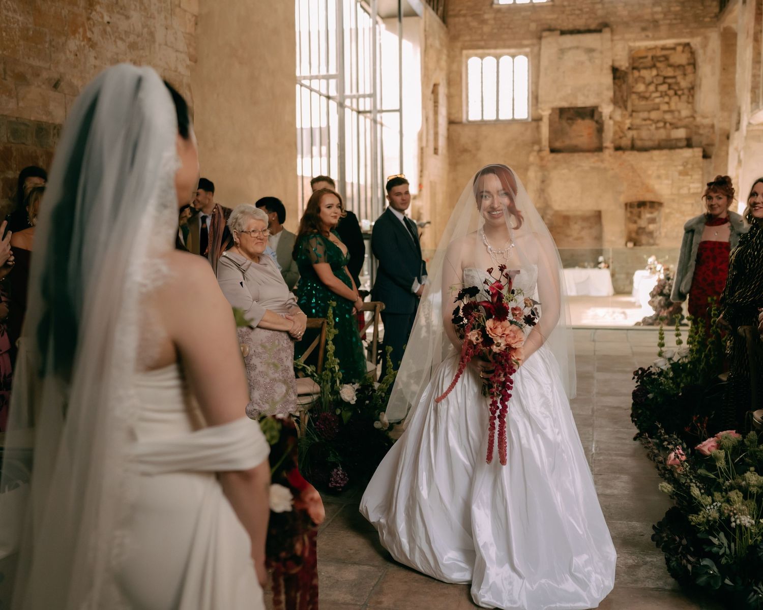 A panoramic collage of a wedding ceremony in a rustic stone church interior with white gowns and gathered guests.