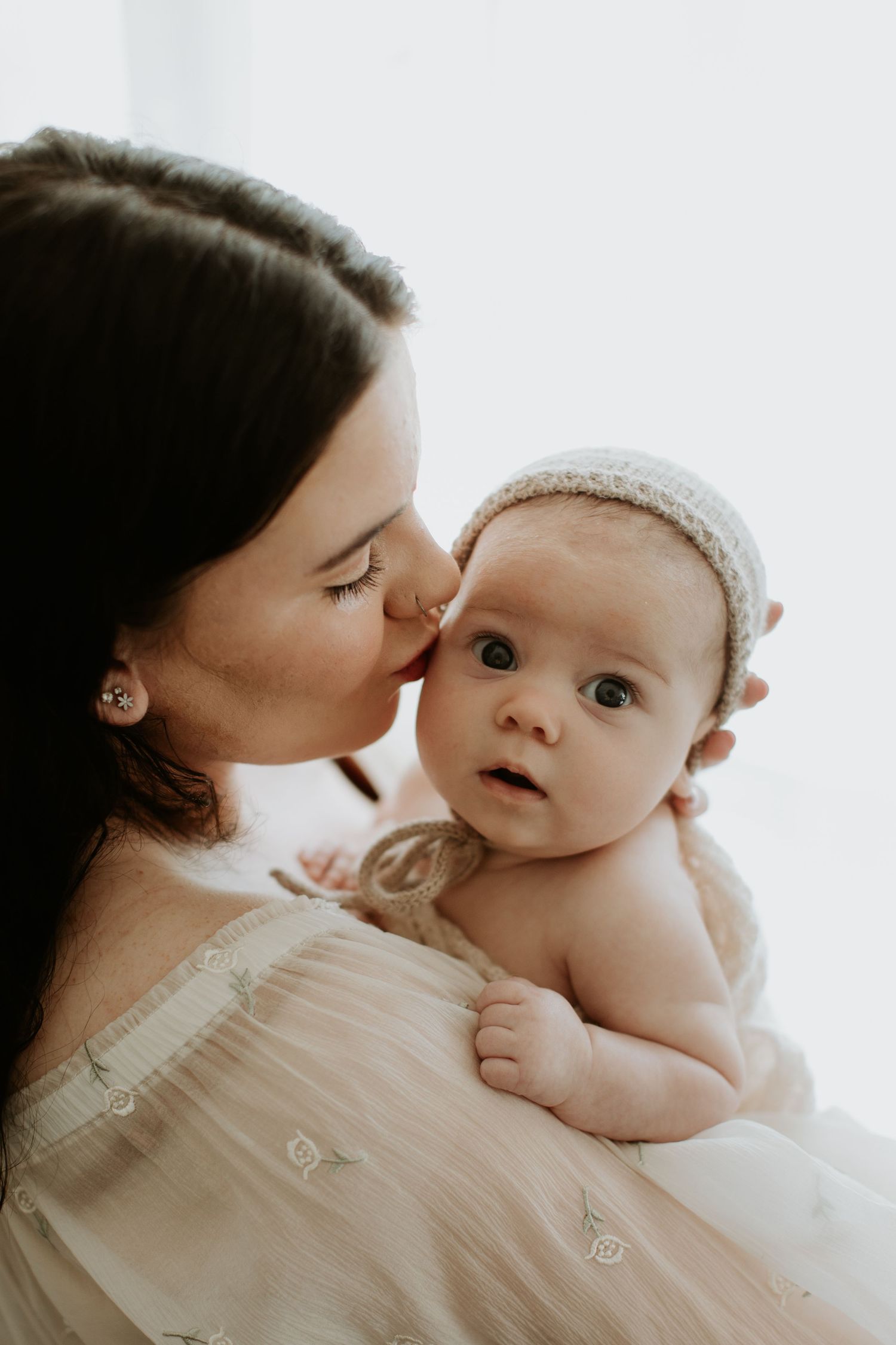 A tender moment between a mother and baby captured in a series of intimate black and white photographs.