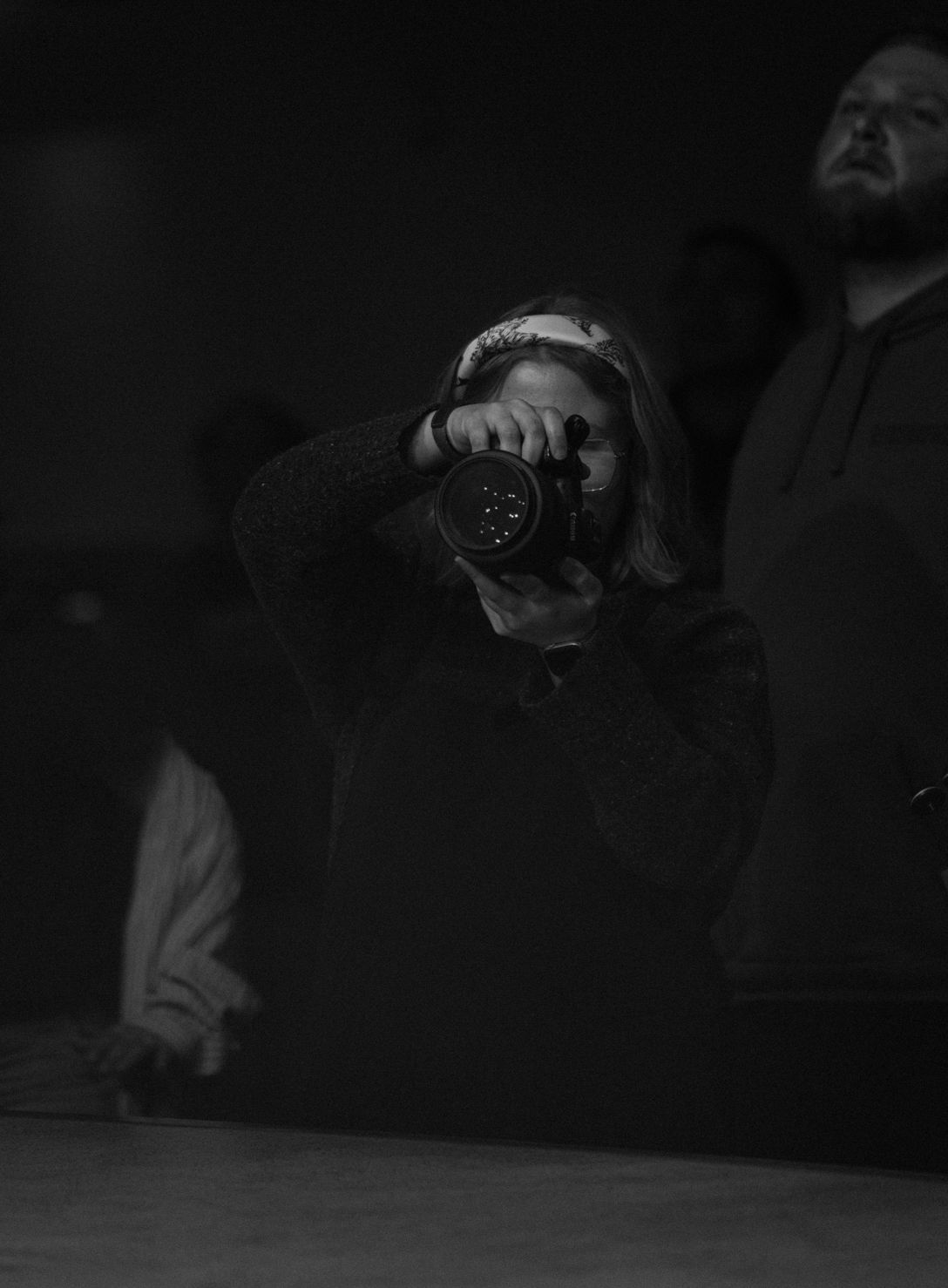 Dark atmospheric photo showing silhouettes in low light conditions.