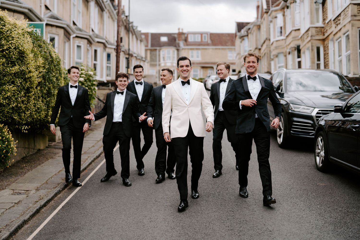 groom and groomsmen walking and laughing at Hamswell house wedding in bath