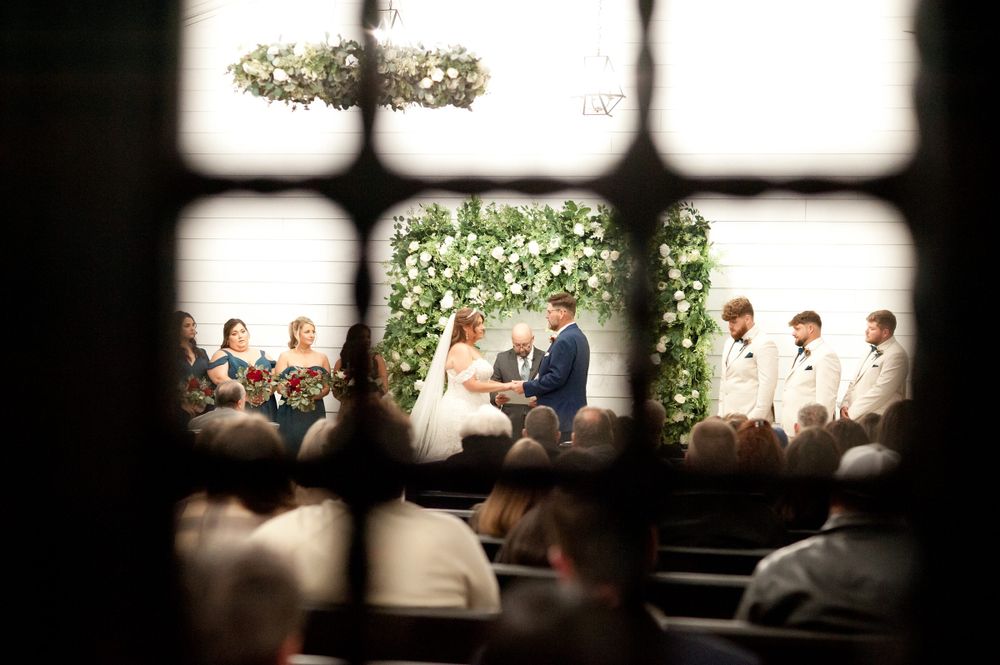 Artistic silhouette shots of wedding guests seated in church pews during ceremony.