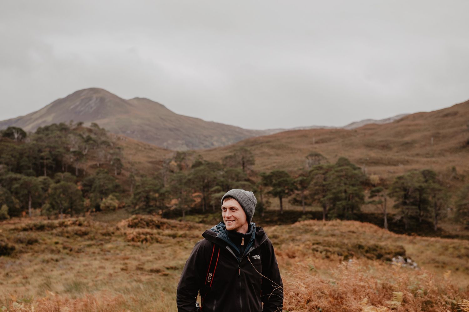 Ben Queenborough standing in a Scottish lanscape with mountains and stark grassland
