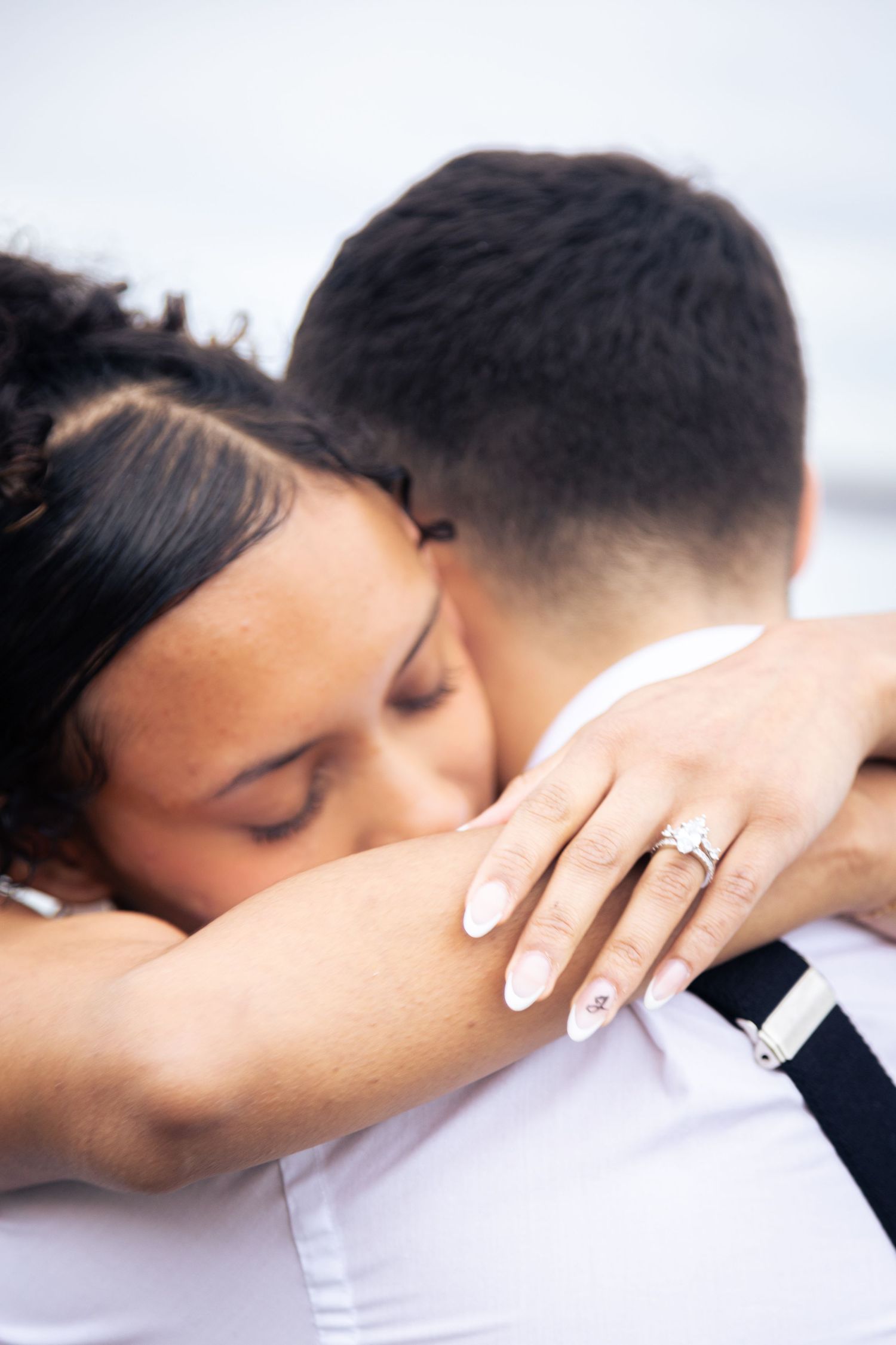 A romantic couple embraces and kisses in a tender moment captured in a sequence of intimate wedding photos.