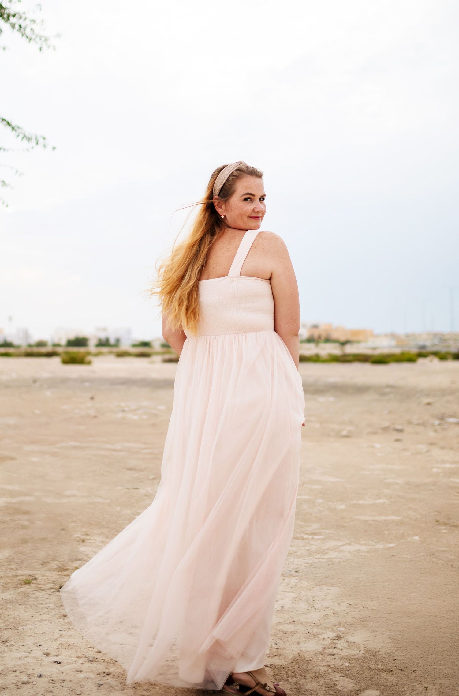 beach photoshoot in abu dhabi clinet closet options cream wrap dress