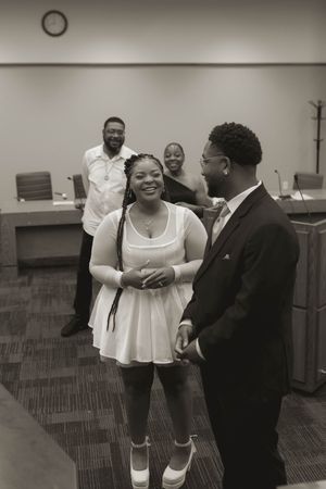 A couple shares a joyful moment in an indoor office space.