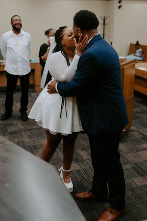 Intimate moments captured between two people in a modern office setting with carpeted floors.