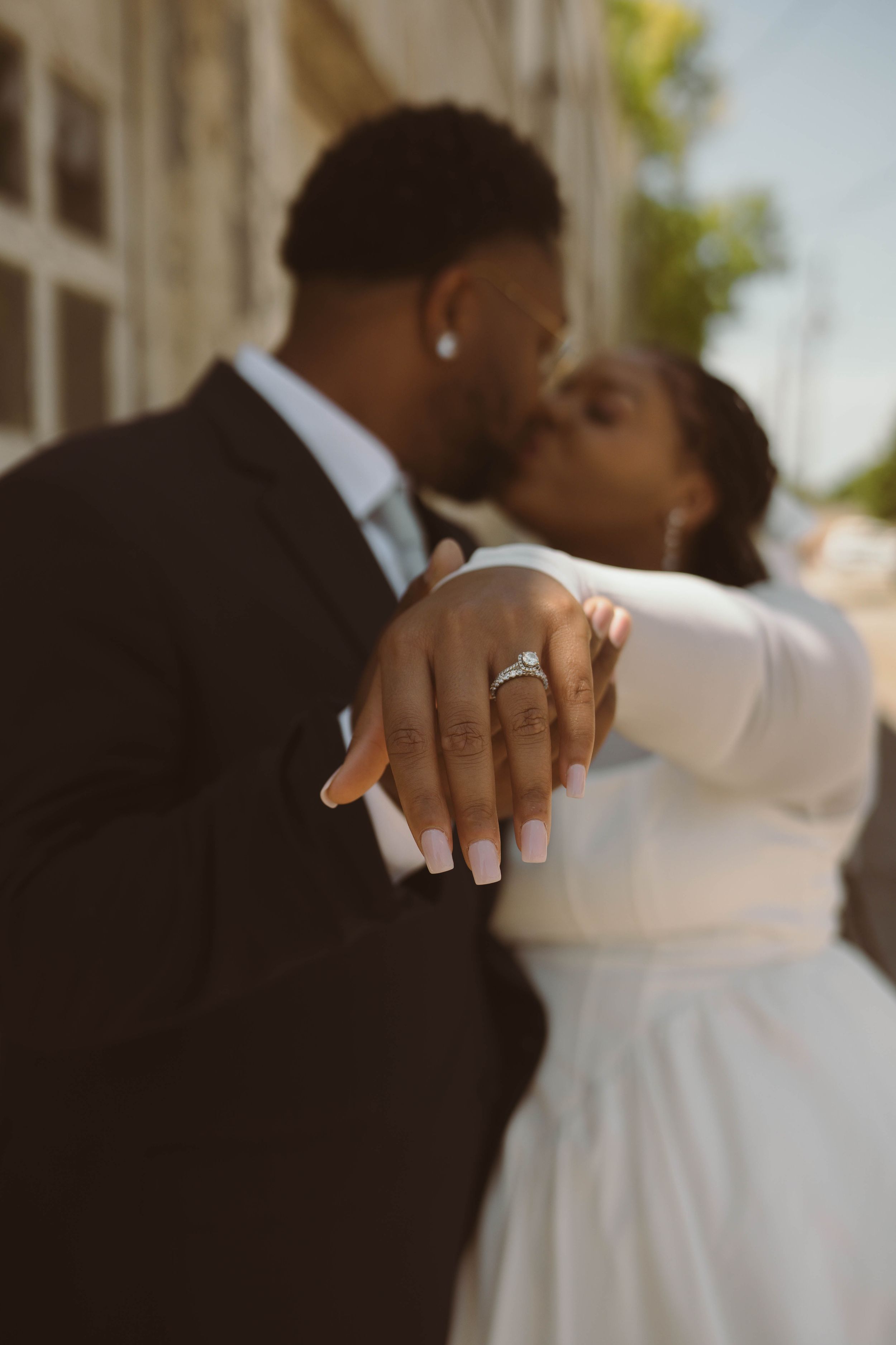 Close-up details of wedding rings and hands during an intimate moment.