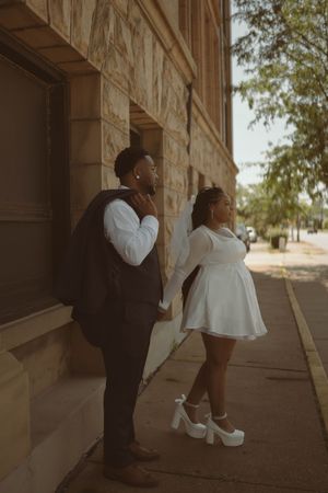 A series of intimate family portraits taken in the shadows of a historic building's archway.