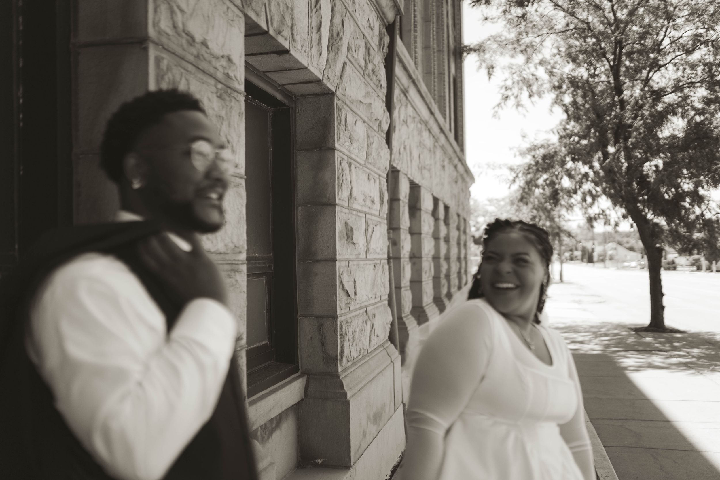 A series of tender moments captured in black and white against an architectural backdrop.