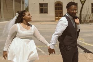 Candid moments of a family in formal attire dancing and playing outside a historic building.