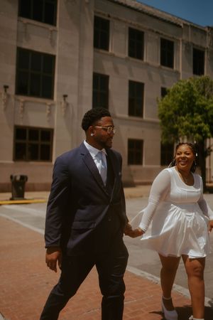A joyful family photoshoot sequence showing movement and laughter outside an urban building.