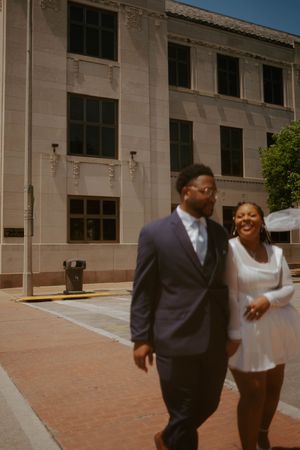 Candid moments of a family laughing and interacting outside a large institutional building.