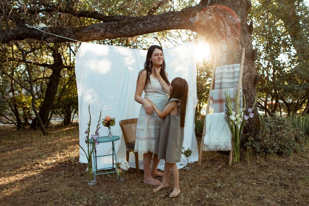 Outdoor photoshoot sequence with white fabric backdrop and natural sunlight filtering through trees.