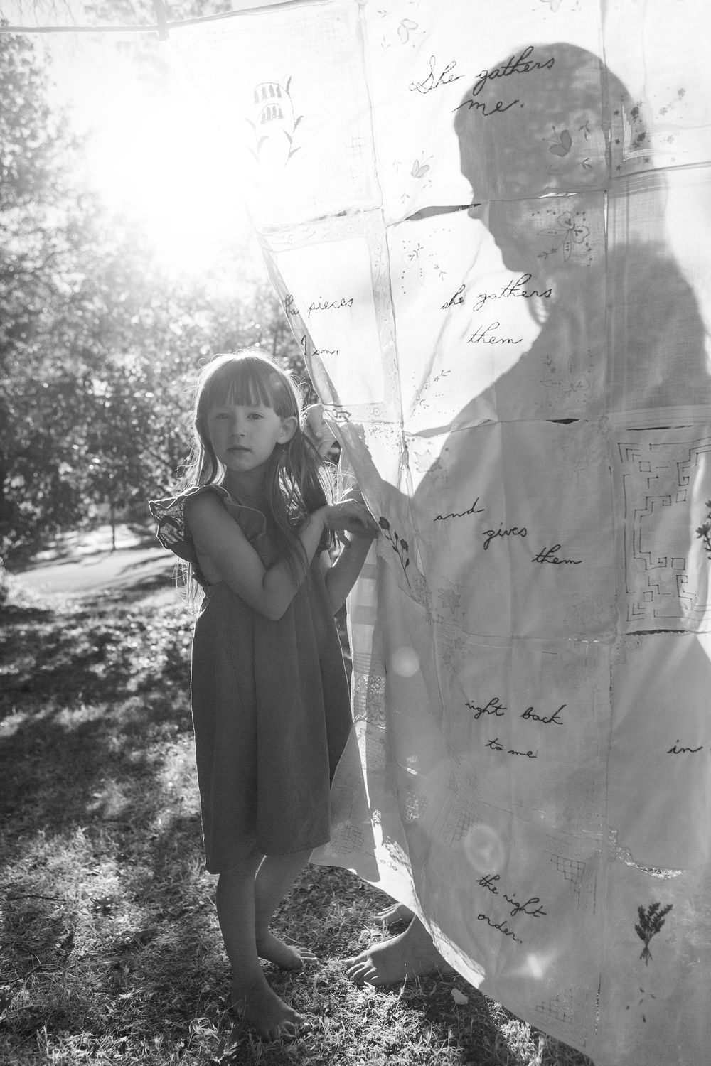 Artistic black and white photos of shadows cast on sunlit sheets hanging outdoors.