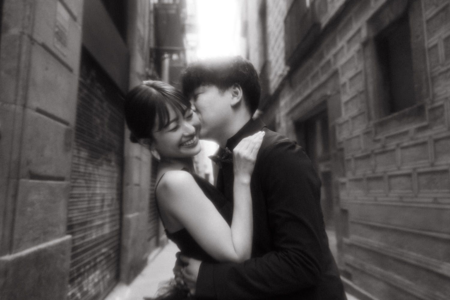 Black and white romantic photos in an urban alleyway setting.