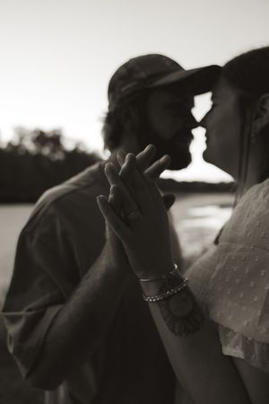 A romantic black and white photo sequence showing an intimate moment at sunset.