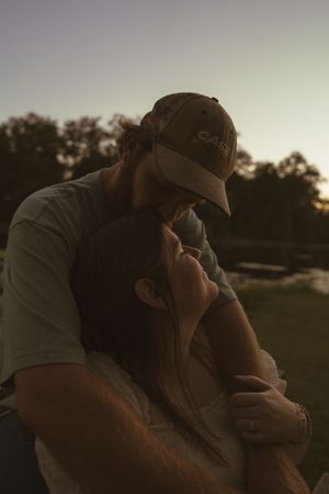 Intimate moments captured in warm evening light against a natural backdrop.