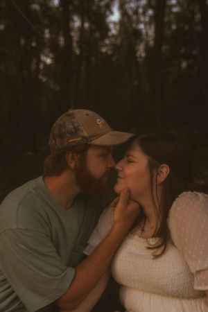 A romantic photo sequence showing tender moments in a wooded setting at dusk.