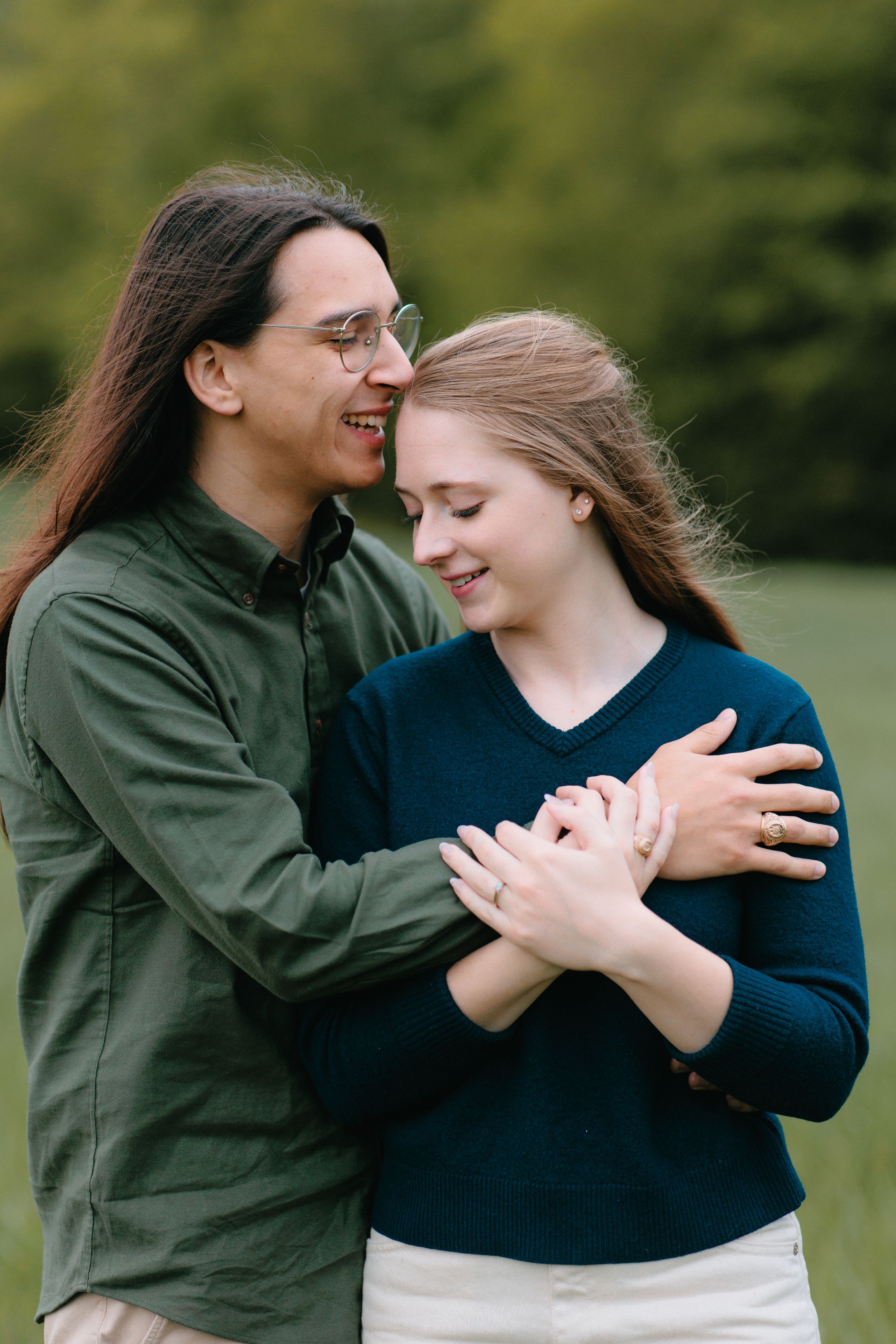 A couple shares a tender dance outdoors, smiling and embracing in a series of candid dancing poses.