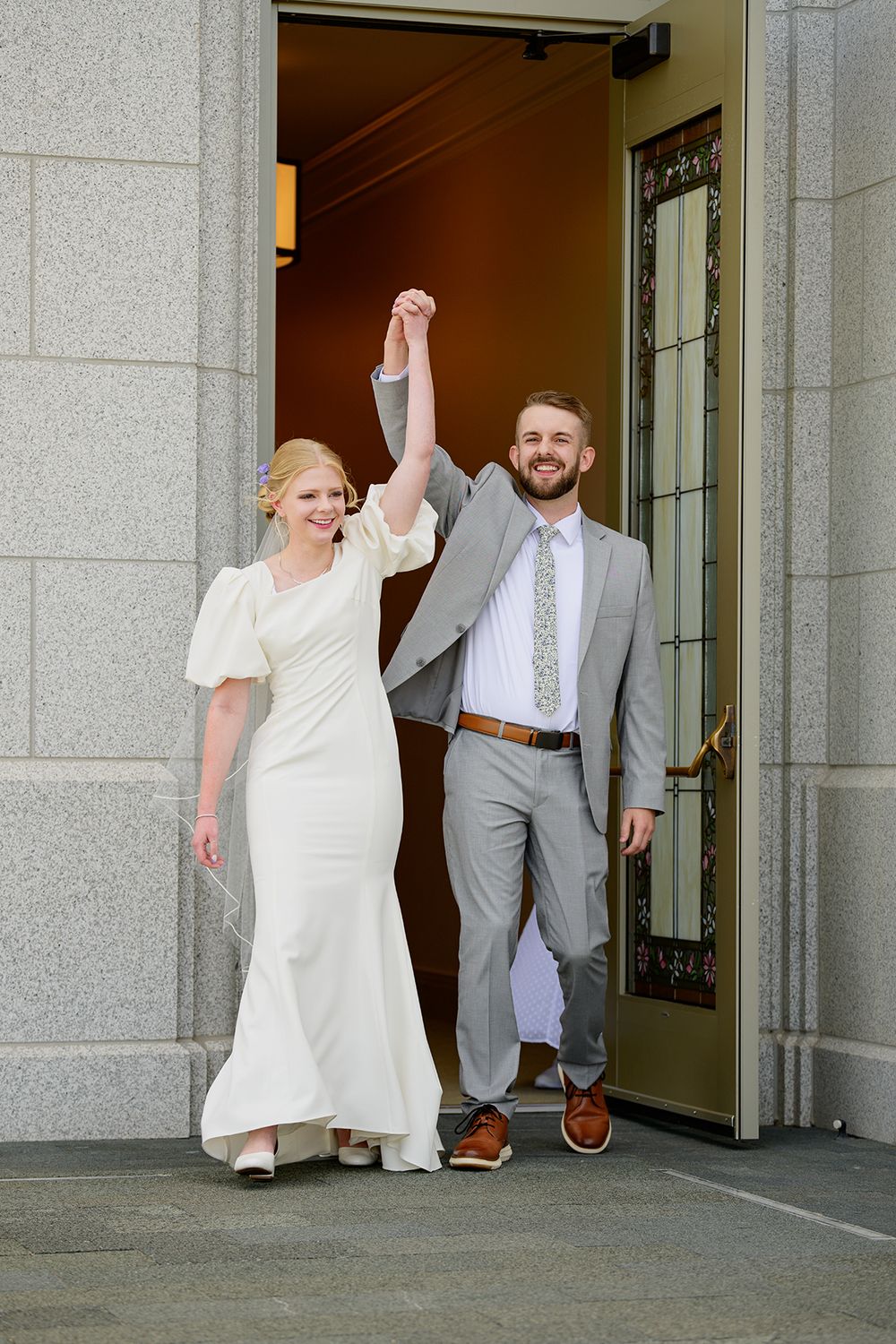 Blackfoot wedding photographer ShutterGirl   candid photo of bride and groom coming out of Pocatello Idaho temple