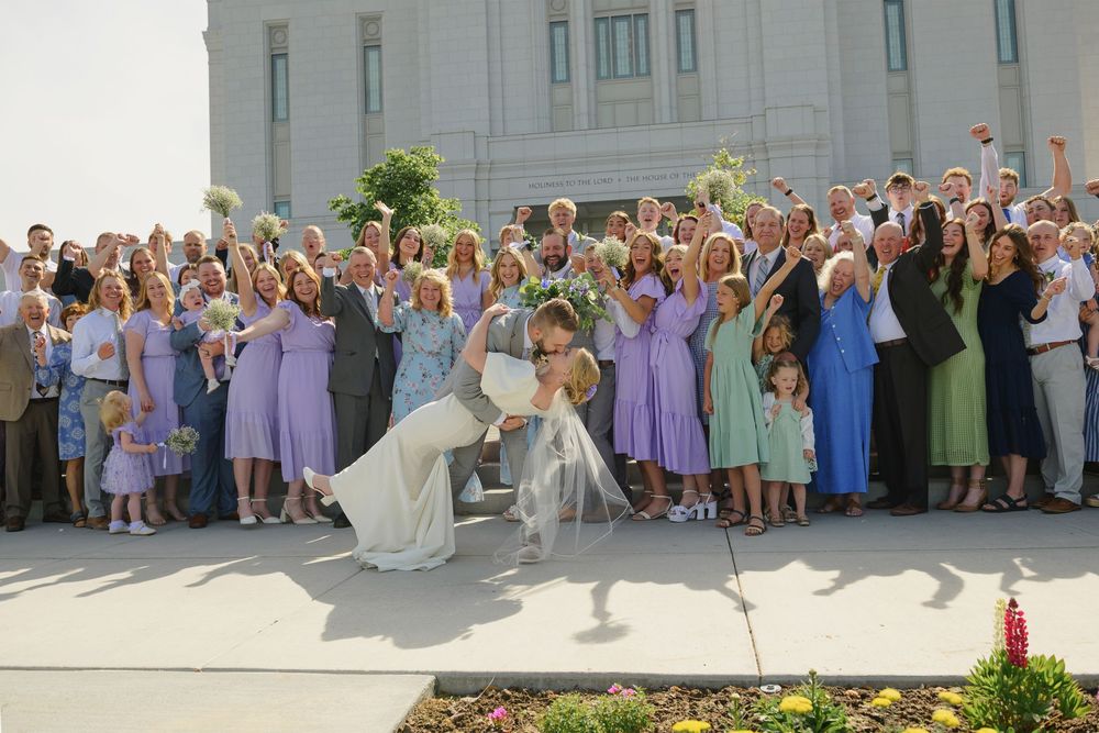 Pocatello wedding photographer Family group shot with bride and groom kissing at Pocatello Idaho Temple