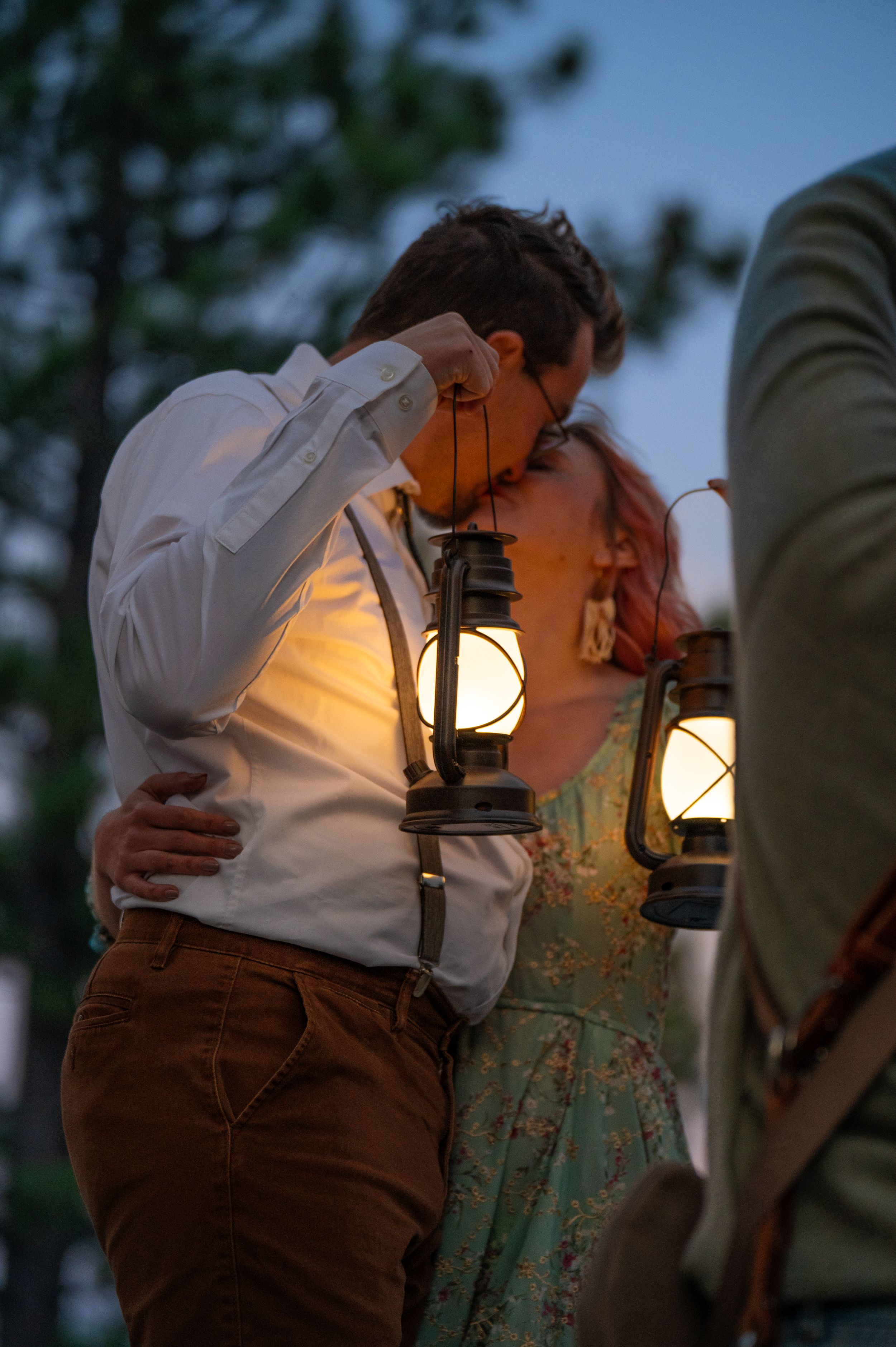 A romantic evening scene with glowing lanterns as a couple shares an intimate moment at dusk.