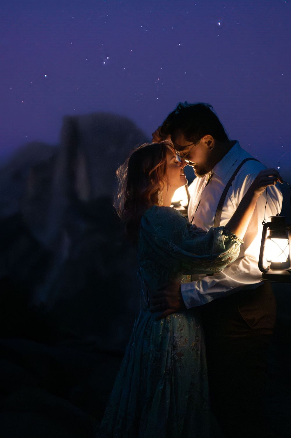 A magical nighttime moment captured with lantern light against a starry backdrop in vintage-style clothing.