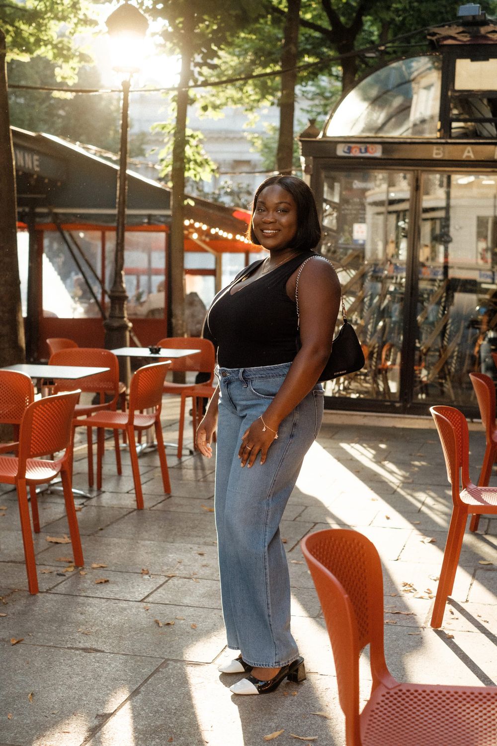 Five sequential photos show a person in denim jeans posing with orange chairs at an outdoor cafe patio during sunset in Paris