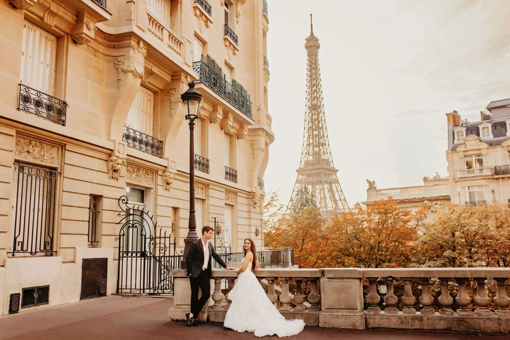Golden hour wedding portrait on a Parisian street with the Eiffel Tower in view.