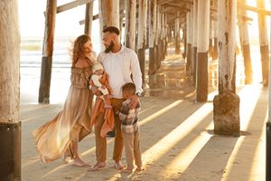 Relaxed family photos on the beach with ocean backdrop
