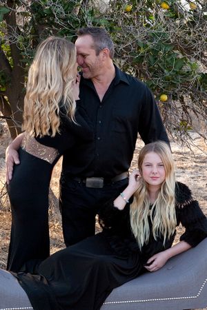 Intimate family moment captured during a San Juan Capistrano session with the family in black