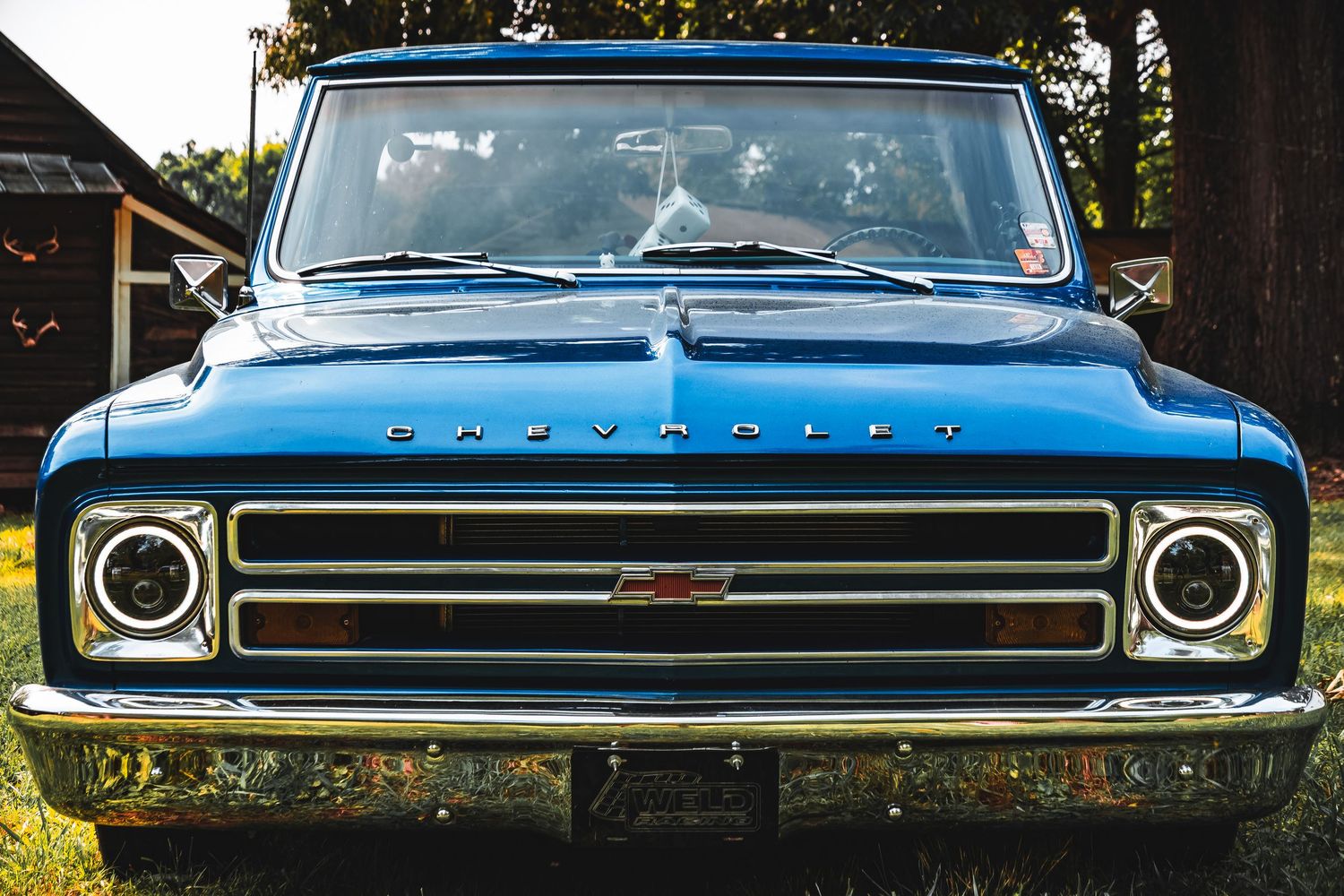 Classic Plymouth car details showing grille, headlights, and front end chrome trim in a series of closeup shots.