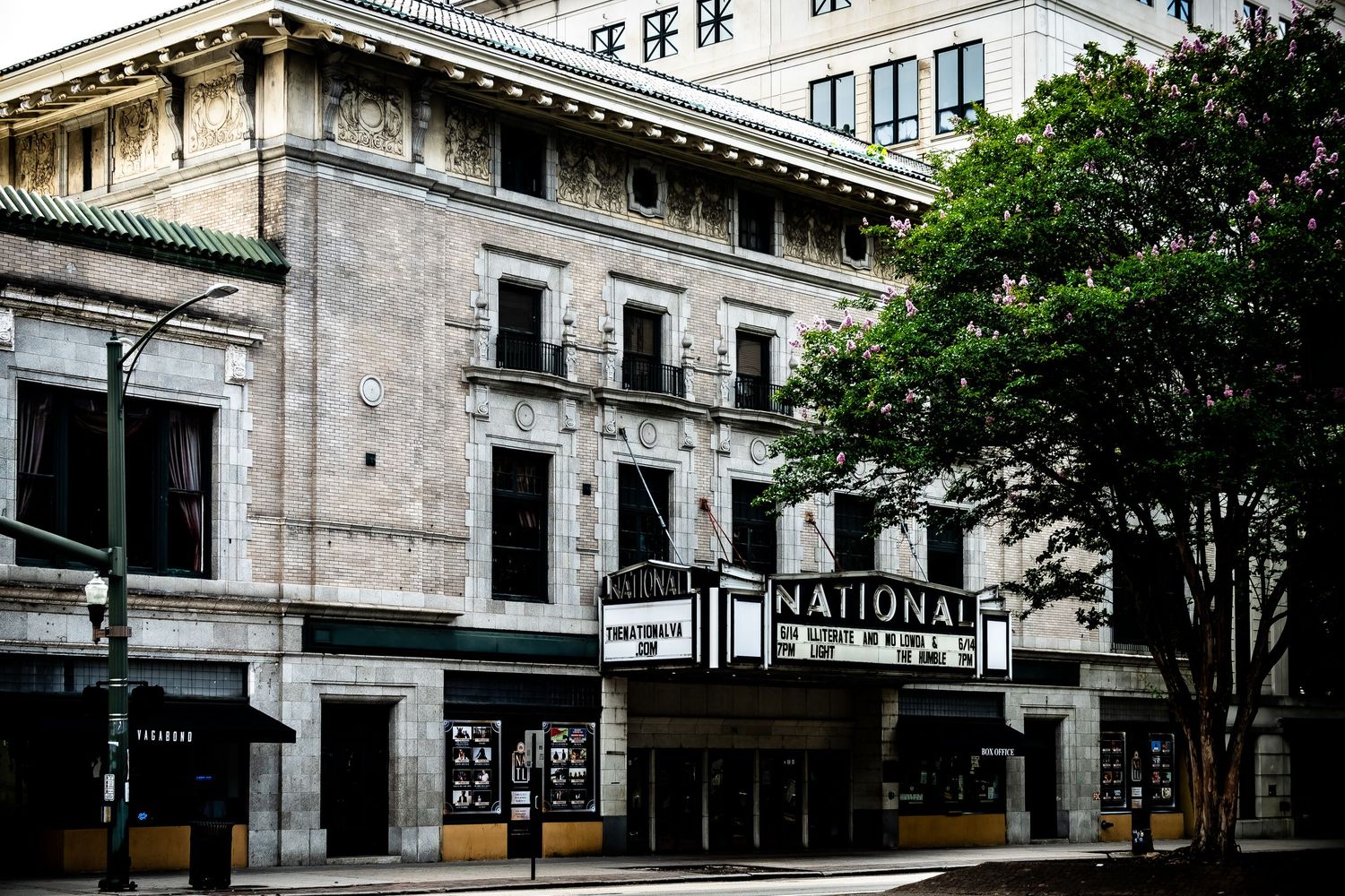 Historic National Theater building with classic architecture and marquee on a downtown street corner.
