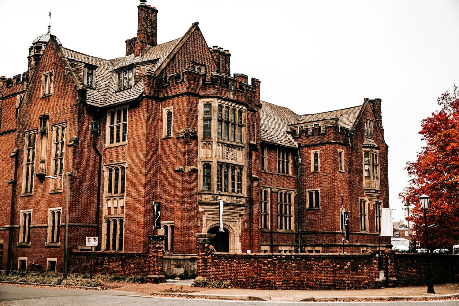 Gothic-style red brick church building with multiple architectural angles shown from different perspectives in autumn.
