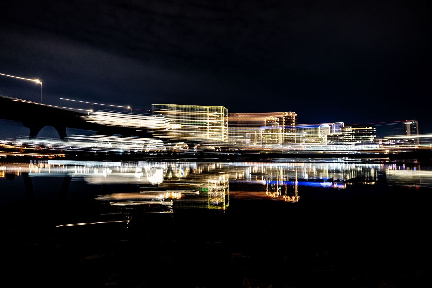 Long exposure nighttime photographs show streaks of light from passing vehicles on a dark highway.