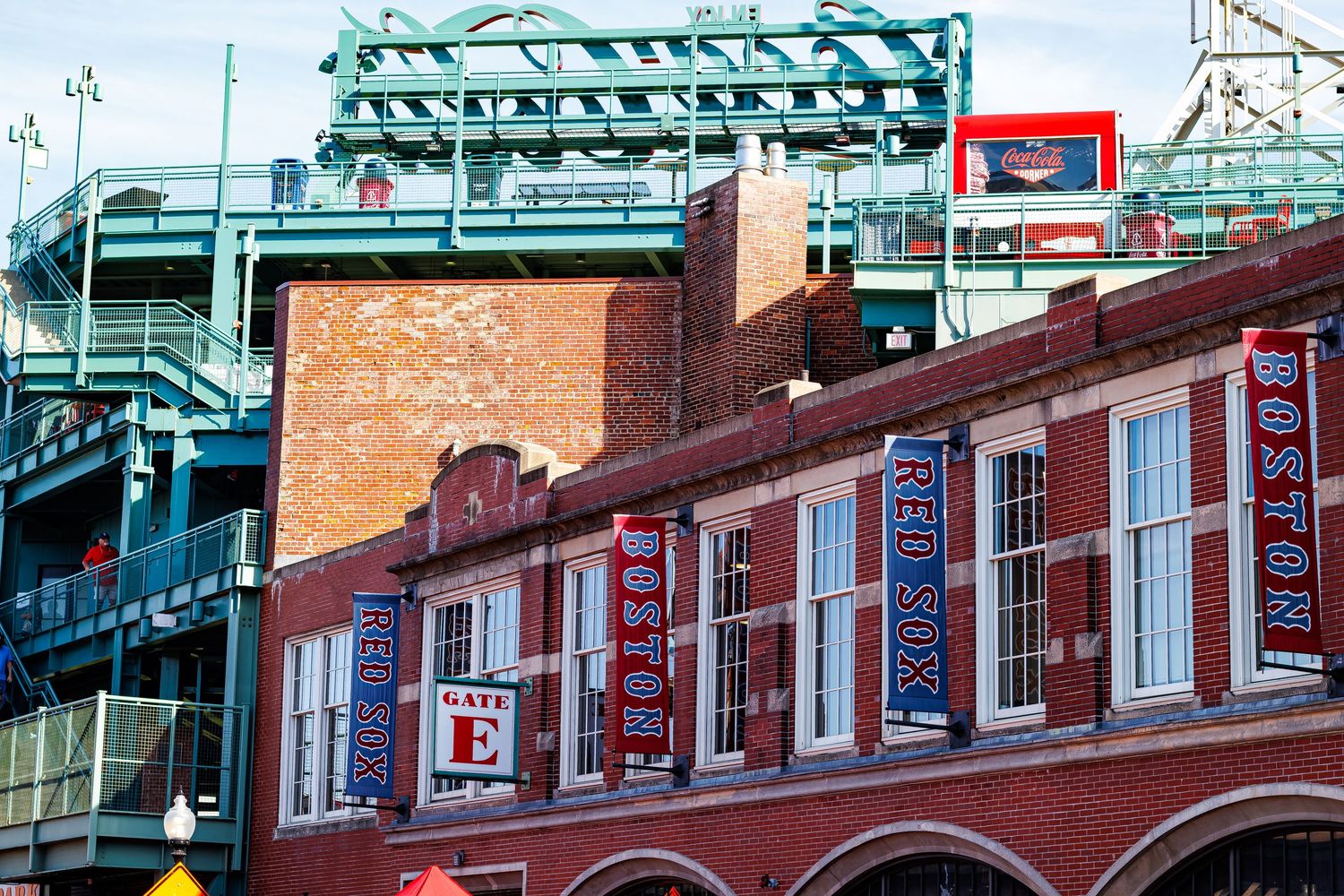 Colorful row of brick buildings with storefronts and awnings along a historic street in Boston's Chinatown district.