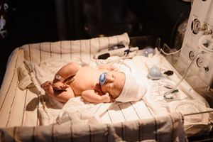 baby under warmer during birth photography session in Marion indiana
