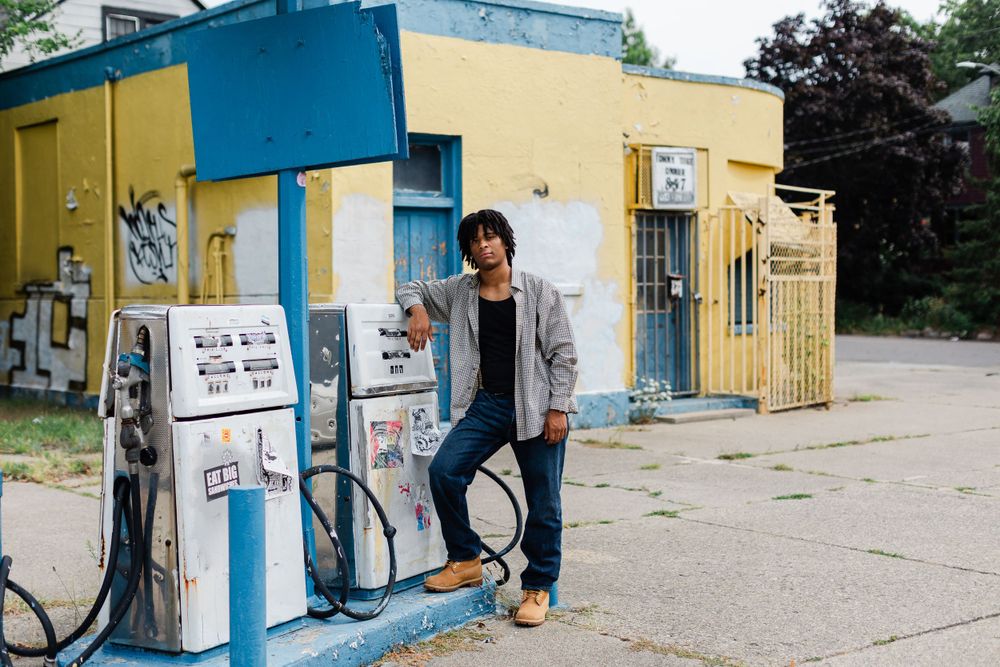 Casual portrait at an abandoned gas station with yellow and blue painted walls.