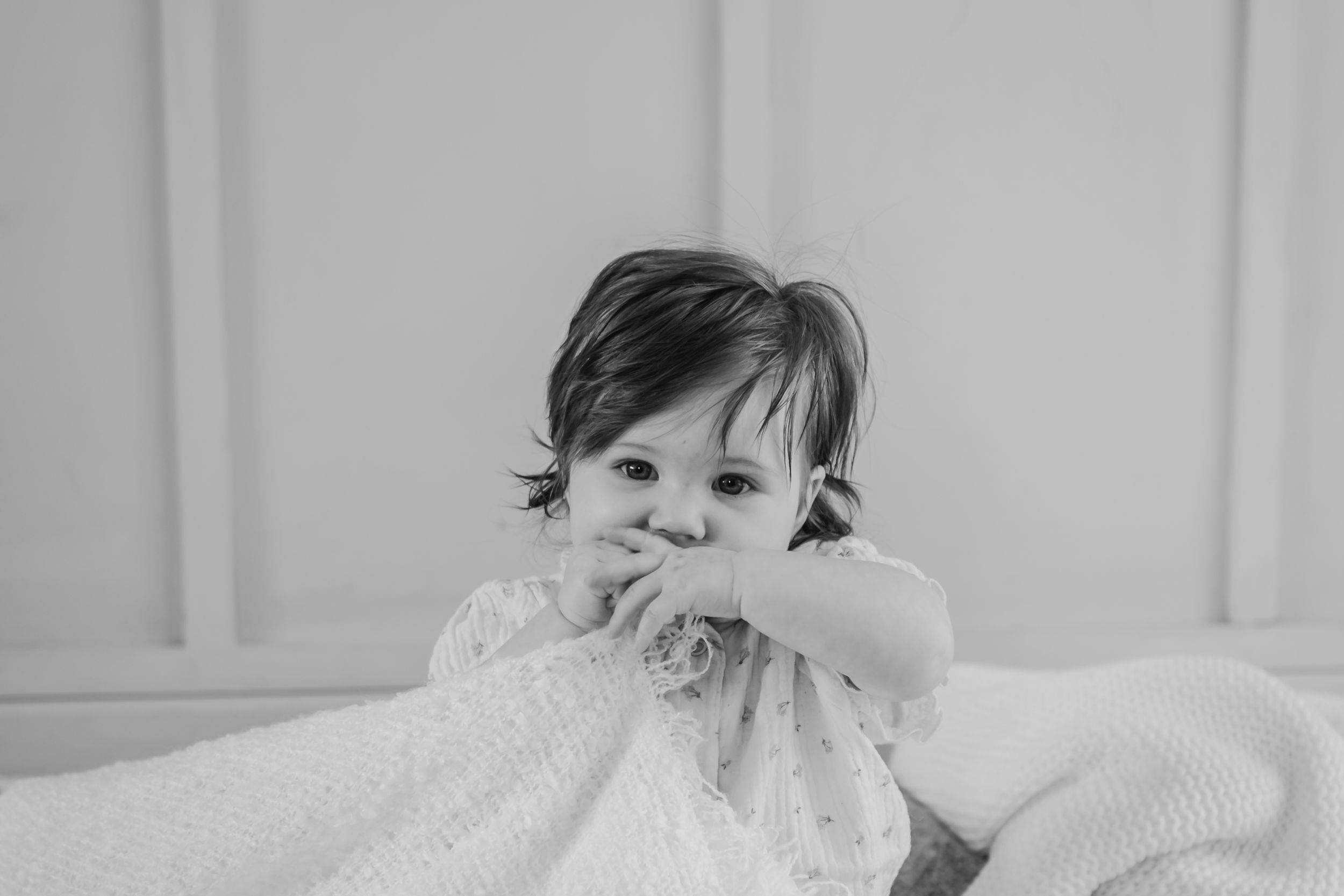 Black and white baby portrait from an in-home milestone session taken in natural light in Portland, Dorset by a newborn photographer
