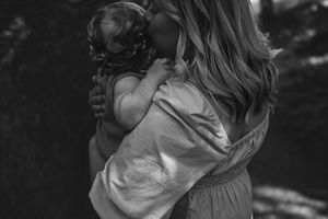 The photographer caught a sweet moment between mother and baby during an in-home and outdoor photography session in Portland, Dorset