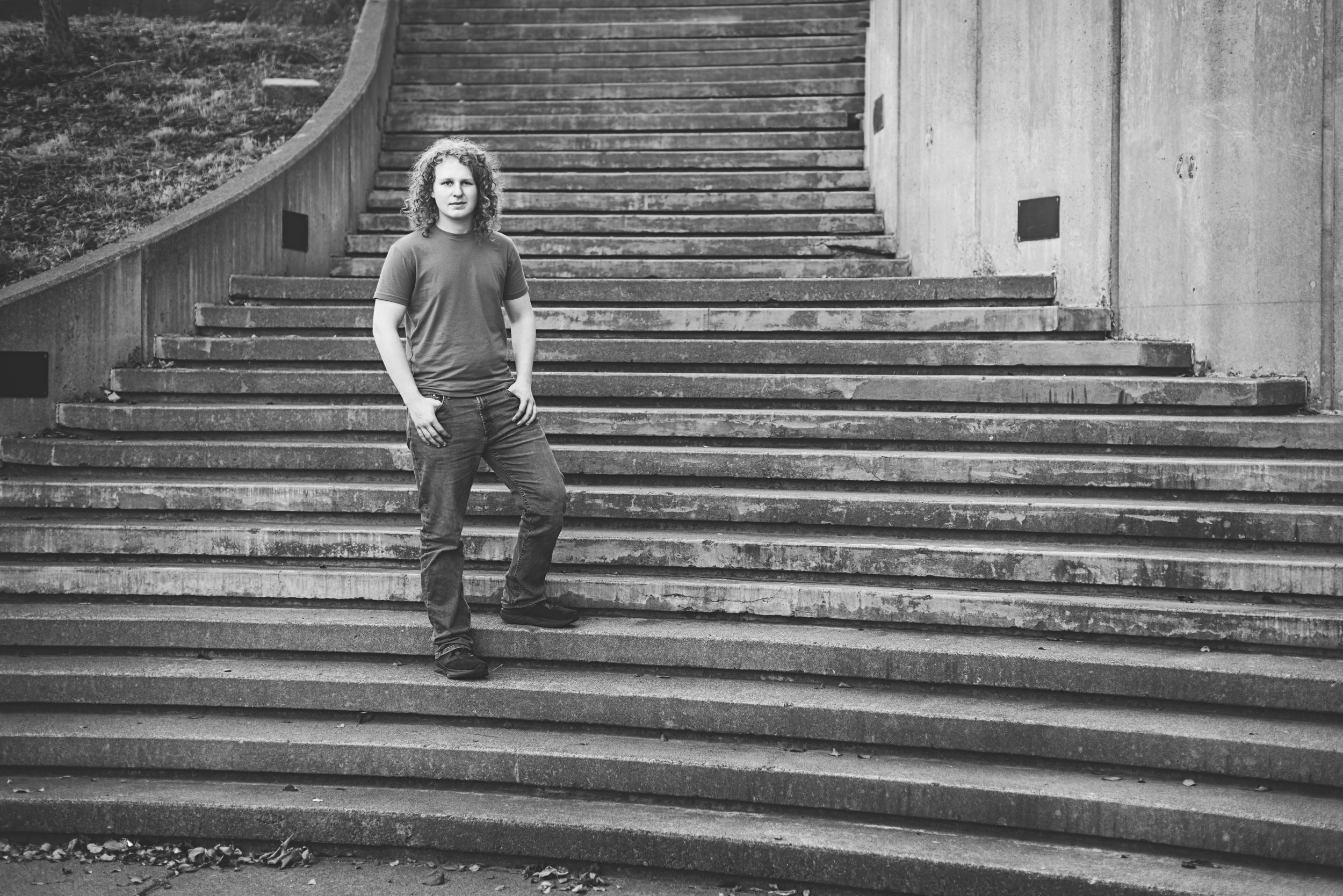 A black and white photo series shows someone sitting in various positions on stone steps.