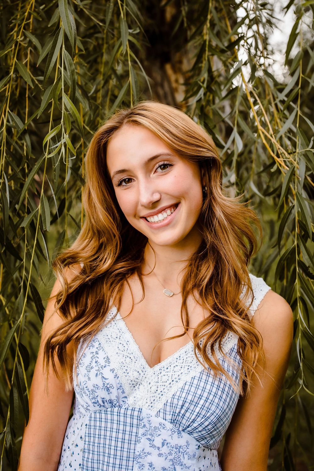 A teen smiles confidently at Wash Park in Denver