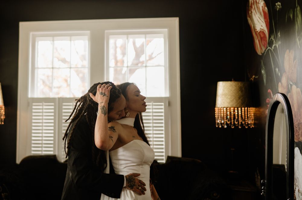 Intimate queer couple in their wedding attire moments before the wedding.
