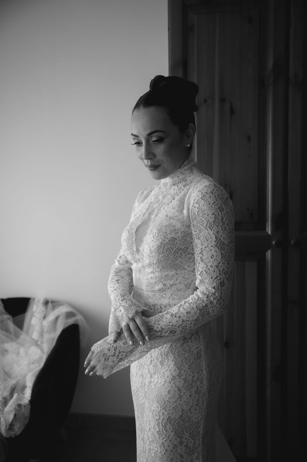 Black and white portrait series of bride in long sleeve lace wedding dress.