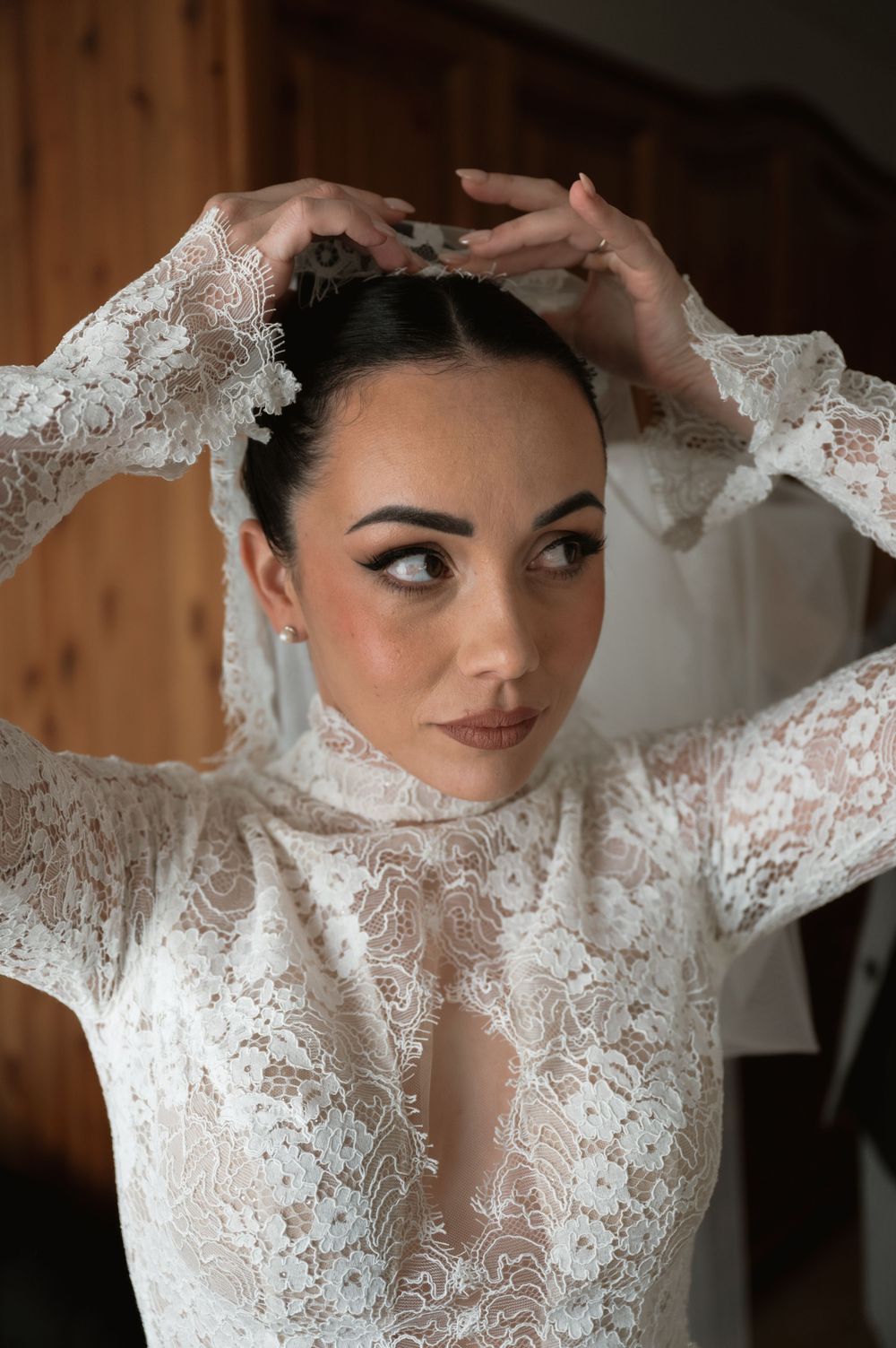 Close-up details of bride's delicate lace sleeves and neckline.