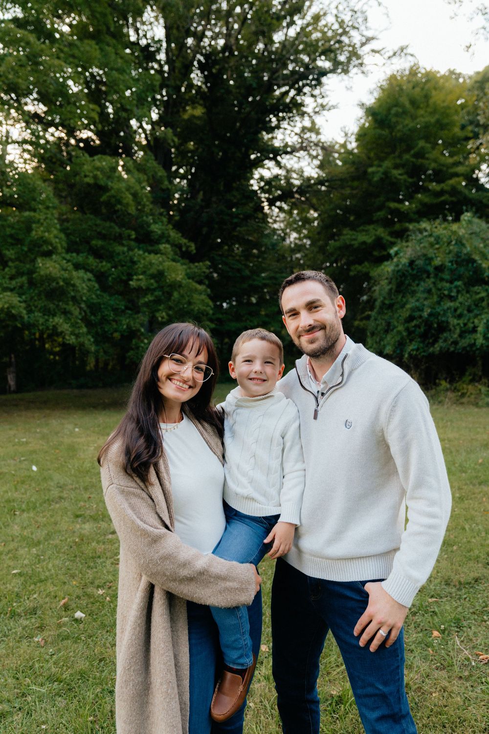 Candid family photo session showing joyful interactions in outdoor setting.