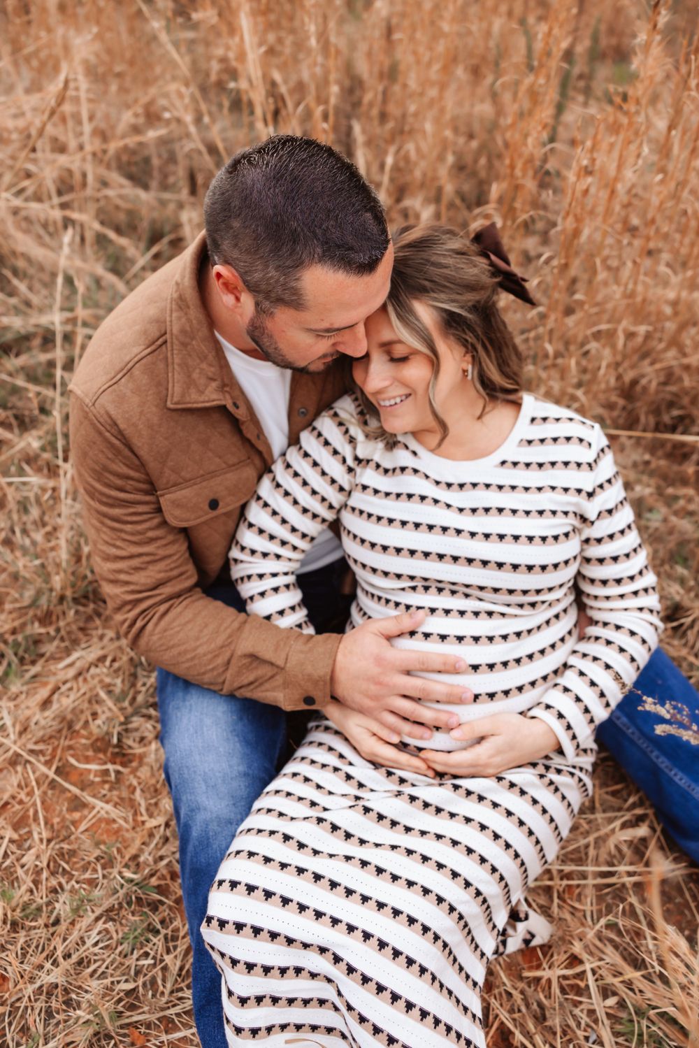 Parents-to-be holding belly during maternity session in Hickory NC