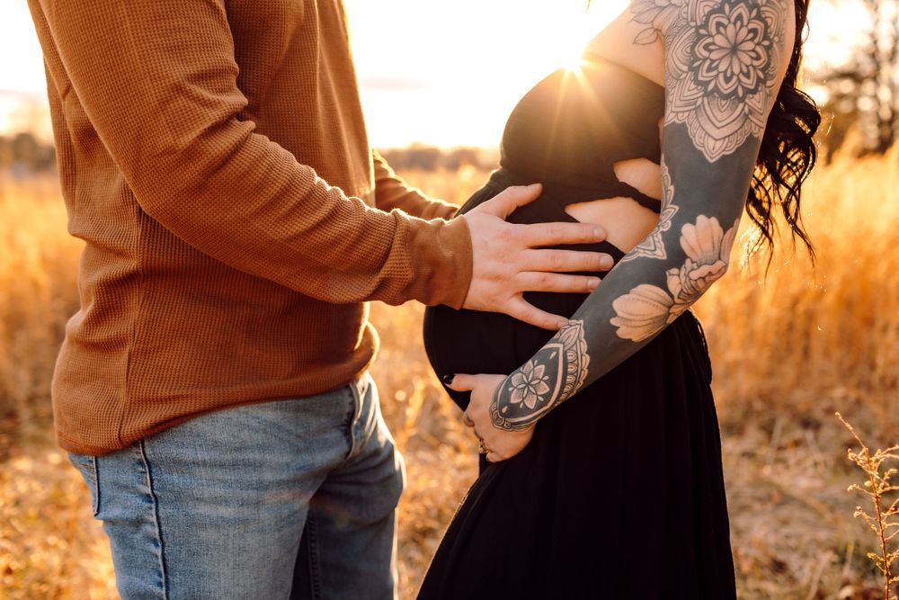 Parents-to-be holding belly during maternity session in Hickory NC