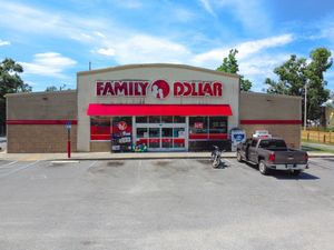 An exterior view of multiple Family Dollar retail stores with red signage and parking lots in different locations.
