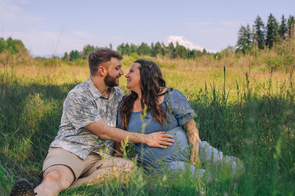 A romantic maternity photo session in a sunlit meadow with wildflowers and trees. Spokane Liberty Lake Photographer Maternity Photographer